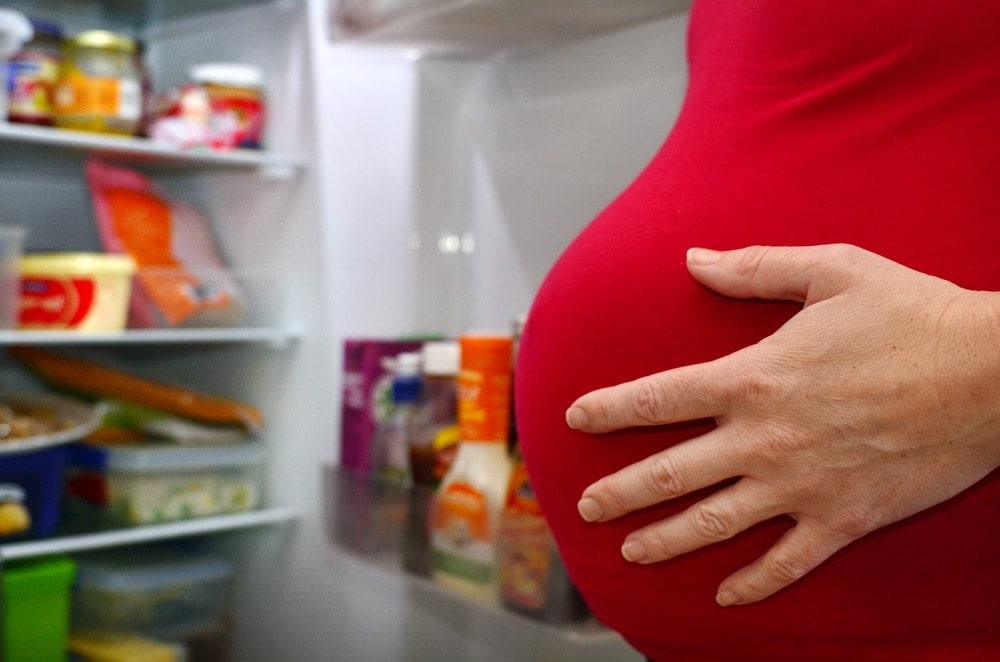 eating-for-two-over-under-weight-pregnant-woman-refrigerator-food | American Pregnancy Association