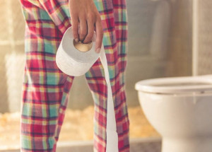 pregnant-woman-with-hemorrhoids-bathroom-toilet-paper-pajamas | American Pregnancy Association