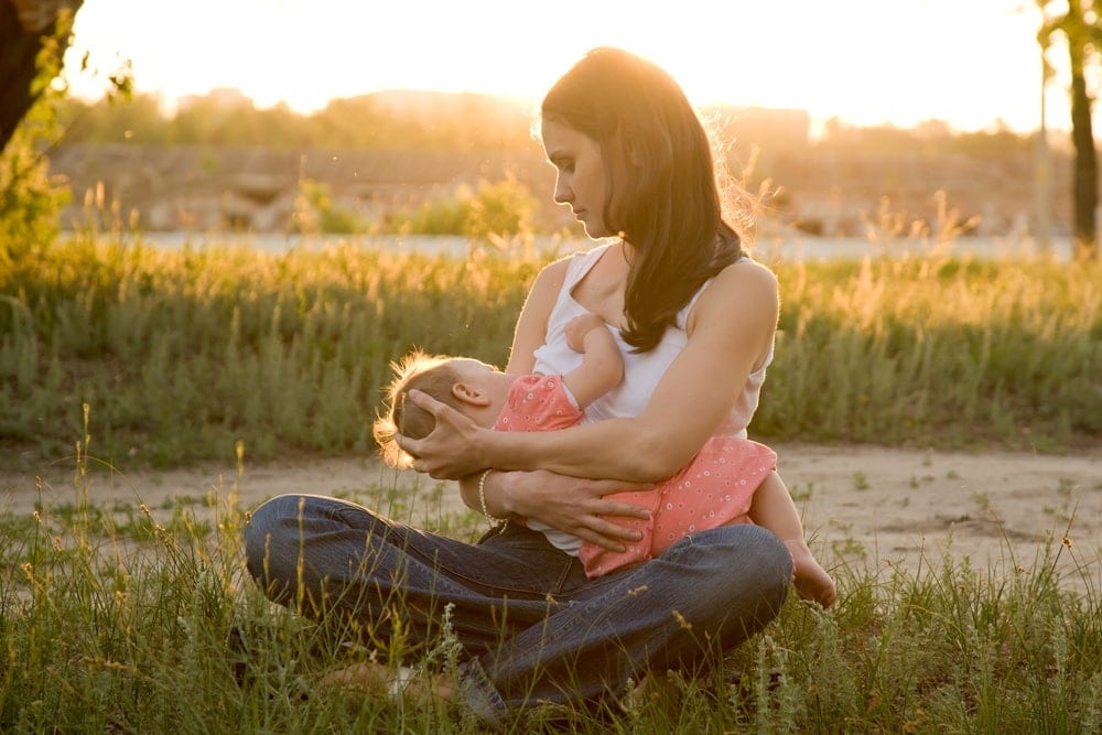 Image of mother with baby preparing to breast pump 